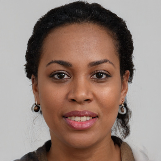 Joyful black young-adult female with medium  brown hair and brown eyes