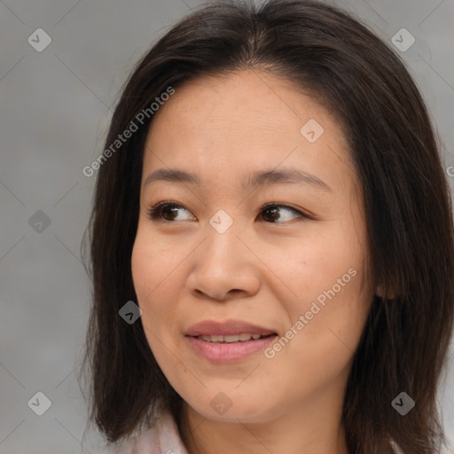 Joyful asian young-adult female with medium  brown hair and brown eyes