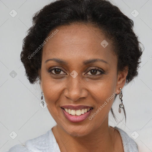 Joyful black adult female with short  brown hair and brown eyes