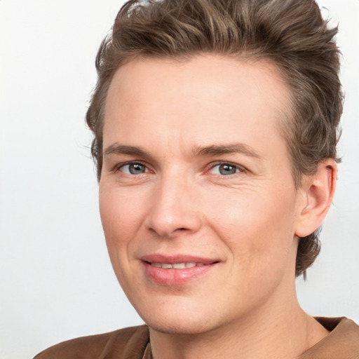 Joyful white adult female with short  brown hair and grey eyes