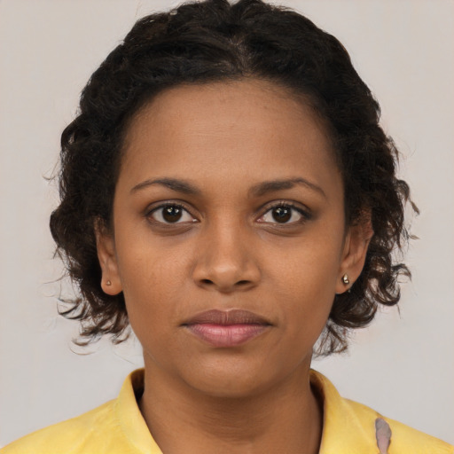 Neutral black young-adult female with medium  brown hair and brown eyes