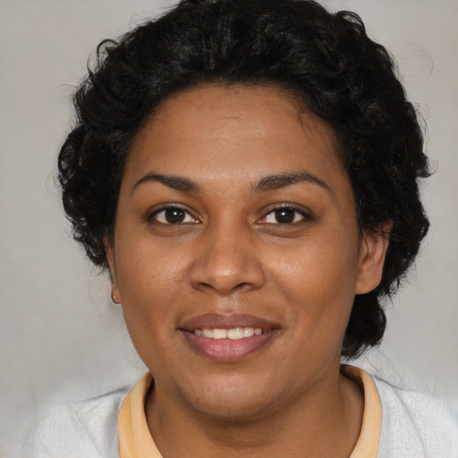 Joyful black young-adult female with medium  brown hair and brown eyes