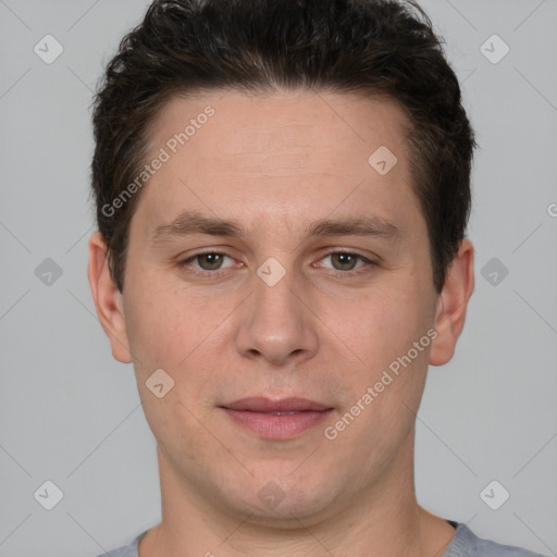 Joyful white young-adult male with short  brown hair and grey eyes