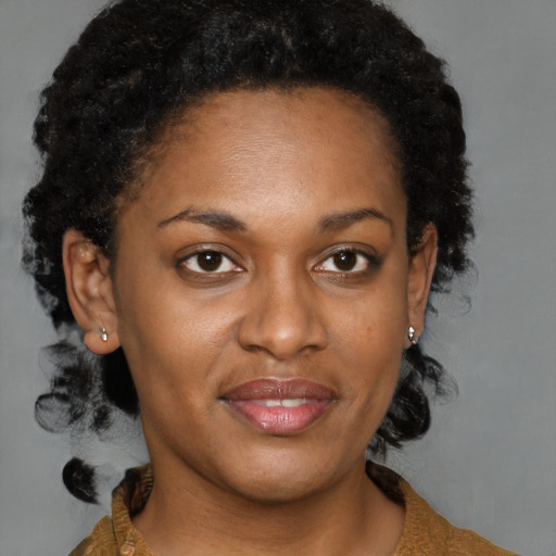 Joyful black adult female with short  brown hair and brown eyes