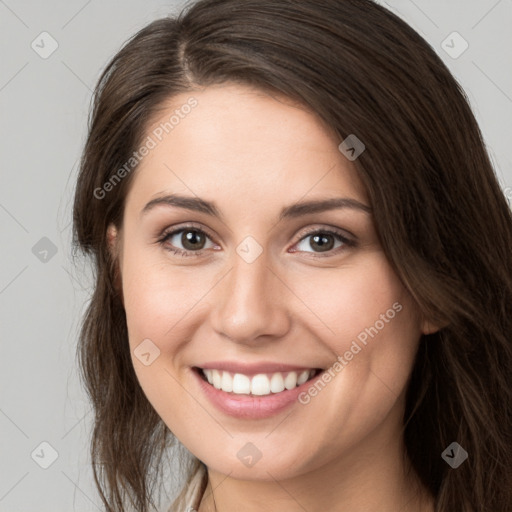 Joyful white young-adult female with long  brown hair and brown eyes