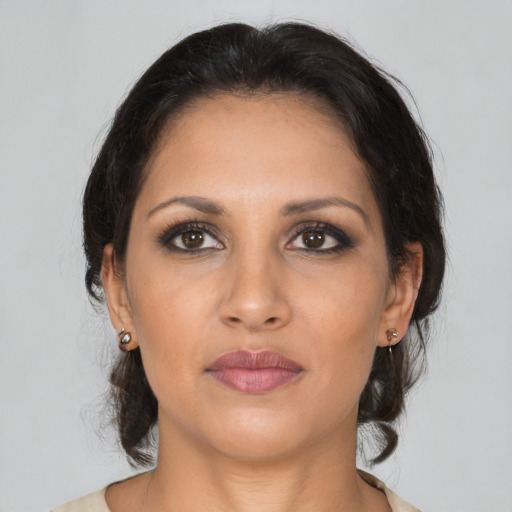 Joyful latino young-adult female with medium  brown hair and brown eyes
