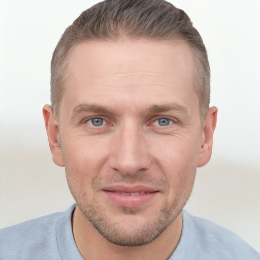 Joyful white adult male with short  brown hair and grey eyes