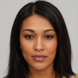 Joyful latino young-adult female with long  brown hair and brown eyes