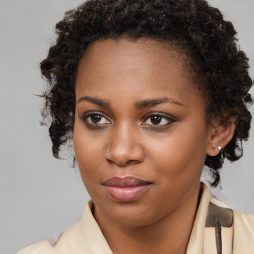 Joyful black young-adult female with short  brown hair and brown eyes