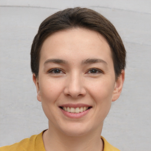 Joyful white young-adult female with short  brown hair and brown eyes