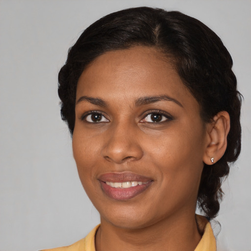 Joyful black young-adult female with medium  brown hair and brown eyes