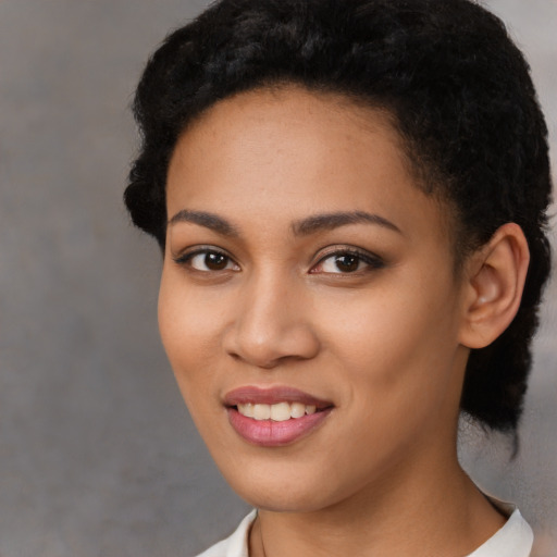 Joyful latino young-adult female with short  black hair and brown eyes