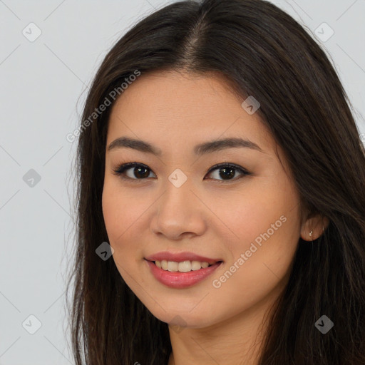 Joyful asian young-adult female with long  brown hair and brown eyes