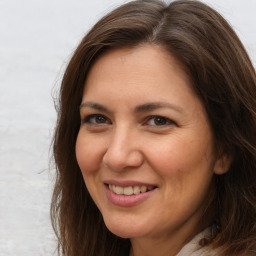 Joyful white adult female with long  brown hair and brown eyes