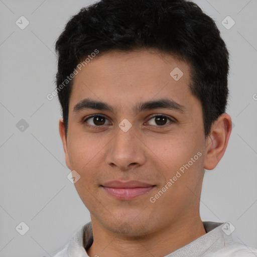 Joyful latino young-adult male with short  brown hair and brown eyes