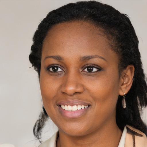 Joyful black young-adult female with medium  black hair and brown eyes