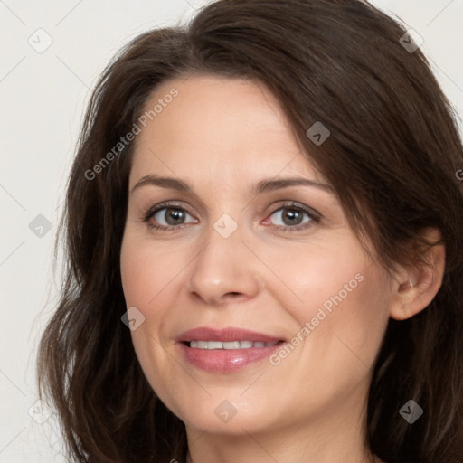 Joyful white adult female with long  brown hair and brown eyes