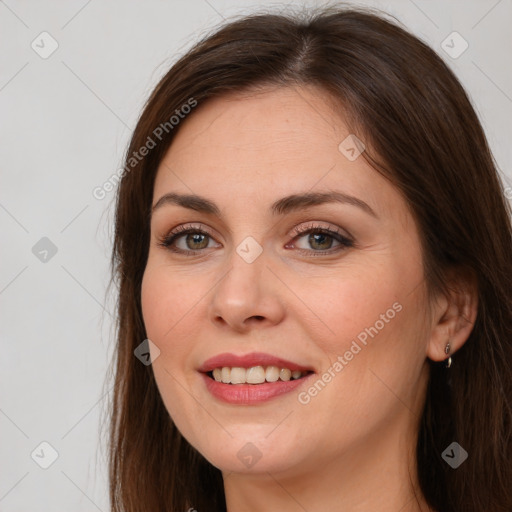 Joyful white young-adult female with long  brown hair and brown eyes