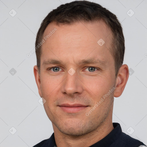 Joyful white adult male with short  brown hair and brown eyes