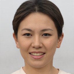 Joyful asian young-adult female with short  brown hair and brown eyes