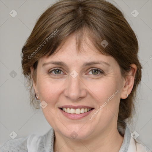 Joyful white adult female with medium  brown hair and grey eyes