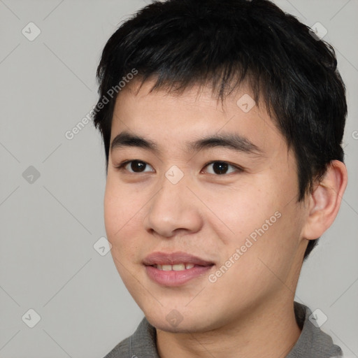 Joyful asian young-adult male with short  black hair and brown eyes