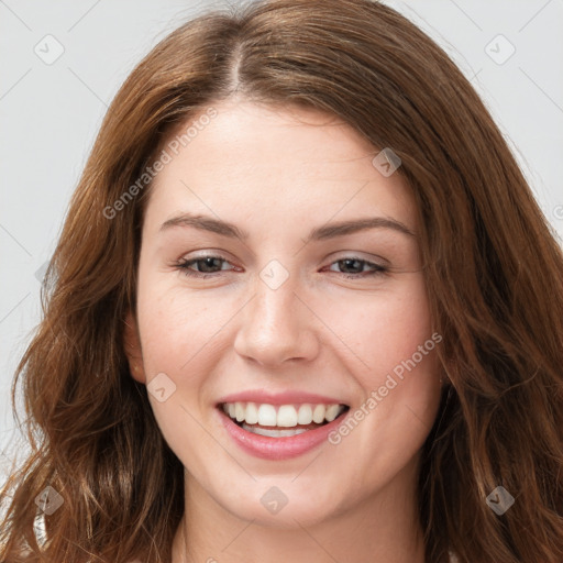 Joyful white young-adult female with long  brown hair and green eyes