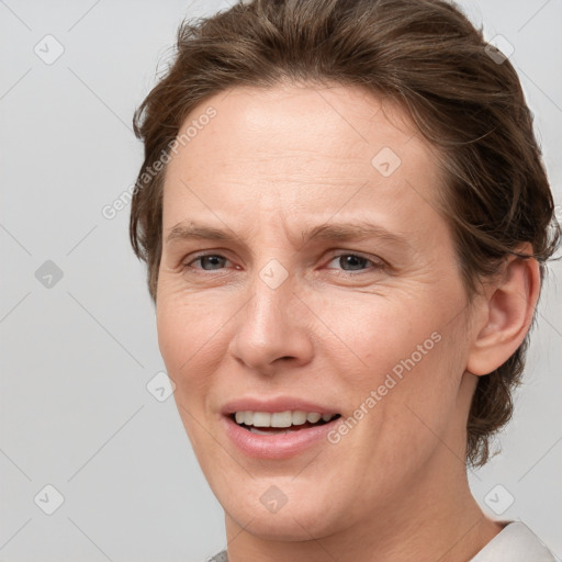 Joyful white adult female with short  brown hair and grey eyes