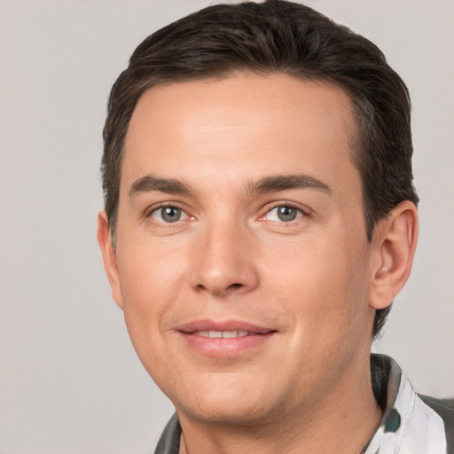 Joyful white young-adult male with short  brown hair and brown eyes