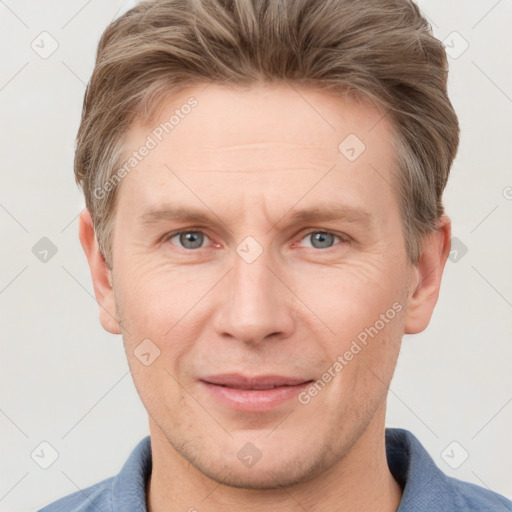 Joyful white adult male with short  brown hair and grey eyes