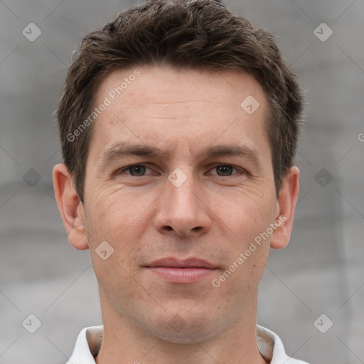 Joyful white adult male with short  brown hair and grey eyes