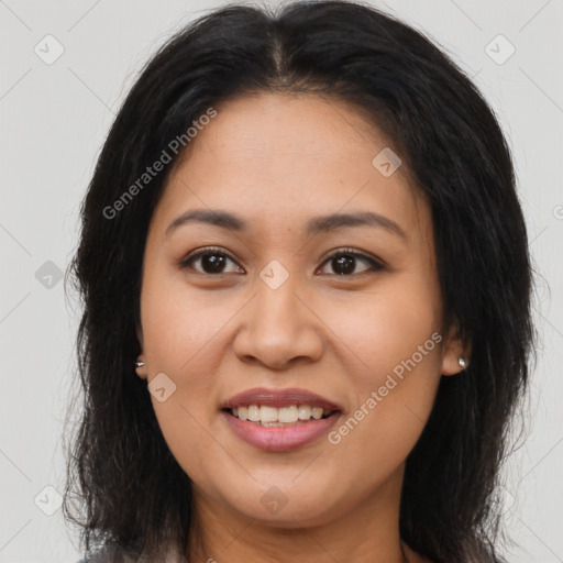 Joyful latino young-adult female with long  brown hair and brown eyes