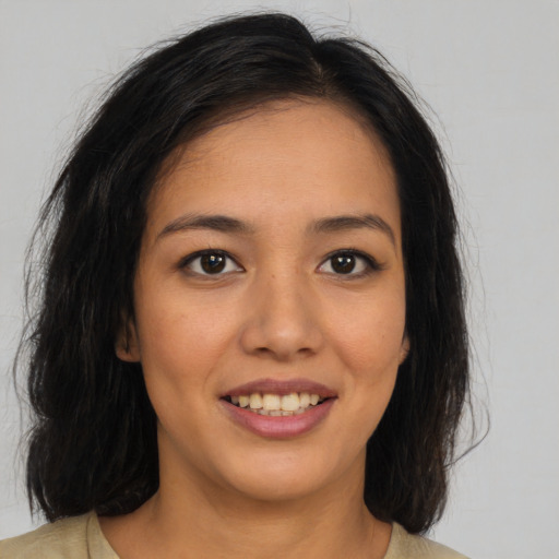 Joyful latino young-adult female with long  brown hair and brown eyes