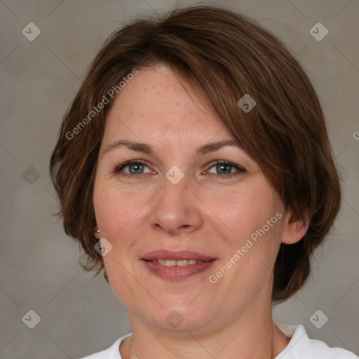 Joyful white adult female with medium  brown hair and grey eyes