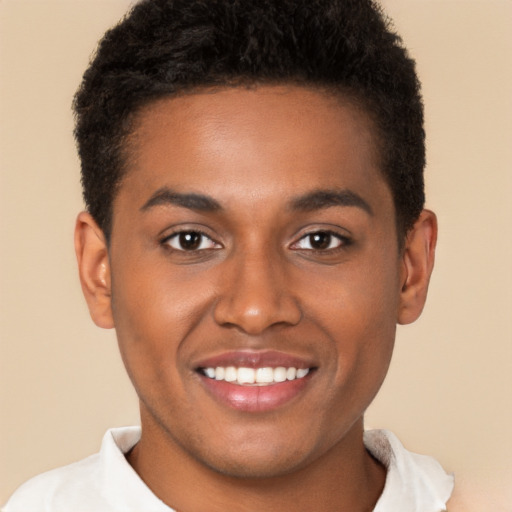 Joyful black young-adult male with short  brown hair and brown eyes