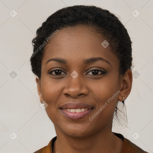 Joyful black young-adult female with short  brown hair and brown eyes