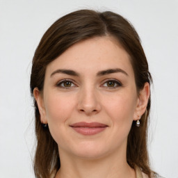 Joyful white young-adult female with medium  brown hair and grey eyes