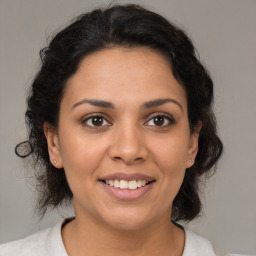 Joyful latino young-adult female with medium  brown hair and brown eyes