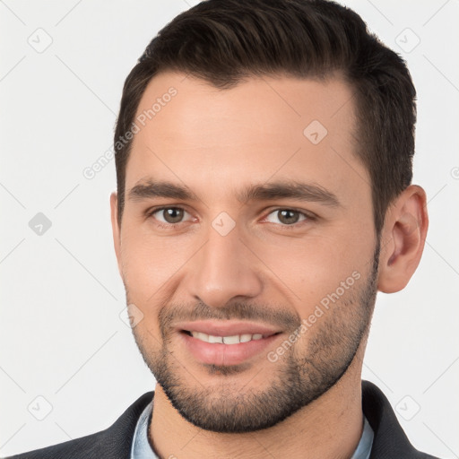 Joyful white young-adult male with short  brown hair and brown eyes