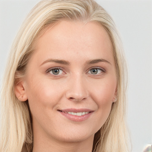 Joyful white young-adult female with long  brown hair and blue eyes