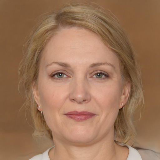 Joyful white adult female with medium  brown hair and grey eyes