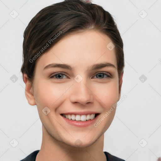 Joyful white young-adult female with short  brown hair and grey eyes