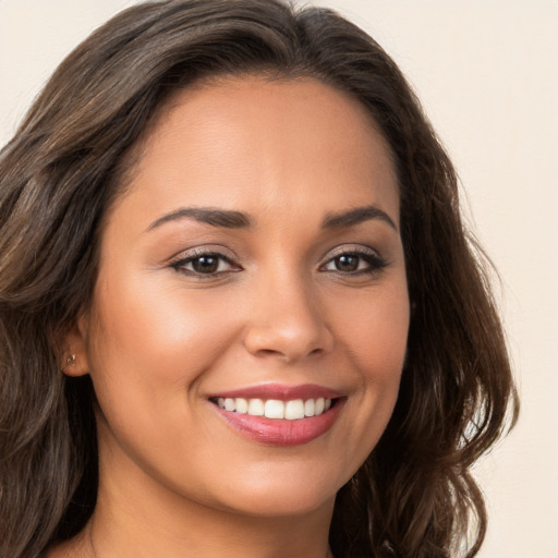 Joyful white young-adult female with long  brown hair and brown eyes