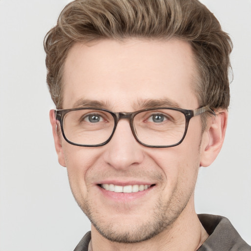 Joyful white adult male with short  brown hair and grey eyes