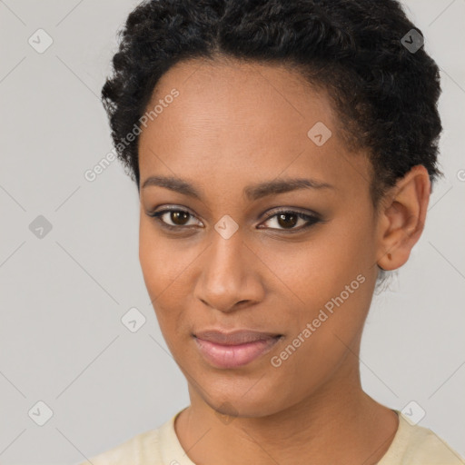 Joyful black young-adult female with short  black hair and brown eyes