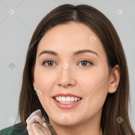 Joyful white young-adult female with long  brown hair and brown eyes