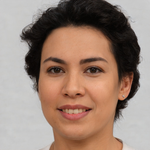 Joyful latino young-adult female with medium  brown hair and brown eyes