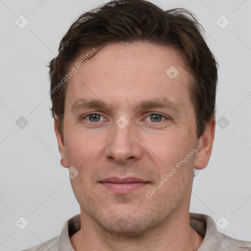 Joyful white adult male with short  brown hair and grey eyes