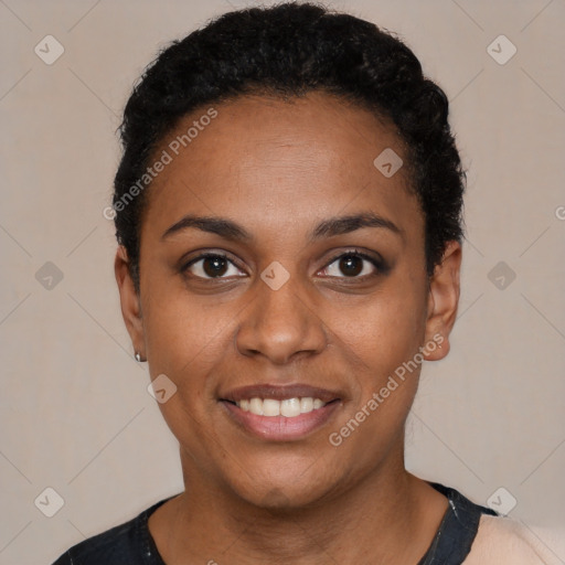 Joyful black young-adult female with short  black hair and brown eyes