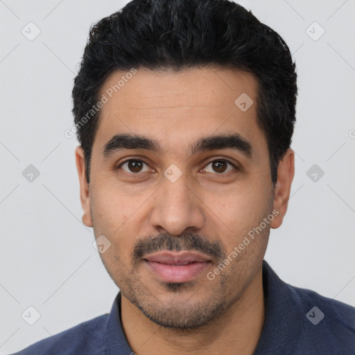 Joyful latino young-adult male with short  black hair and brown eyes